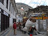 104 Marpha Busy Main Street Marpha�s main street is paved with slabs of stone covering an extensive drainage system. The flat-roofed houses are all neatly whitewashed along the busy narrow street, hectic with people, horses, and donkey trains.